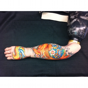 image: painted prosthetic device by Katrie Bonanno with Japanese coy fish design.