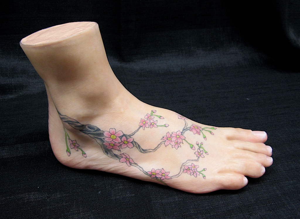 photo: Prosthetic foot tattoo painting by Hudson Valley NY artist Katrie Arena.  Cherry blossom design.  Painted in 2012. Foot with cherry blossom tattoo